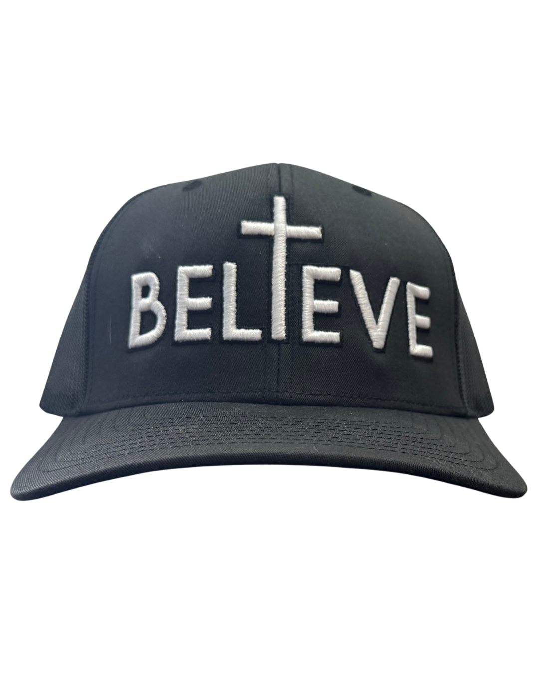 A black snapback hat featuring a white embroidered text that says Believe with the letter 'I" forming a cross to represent Christian faith.