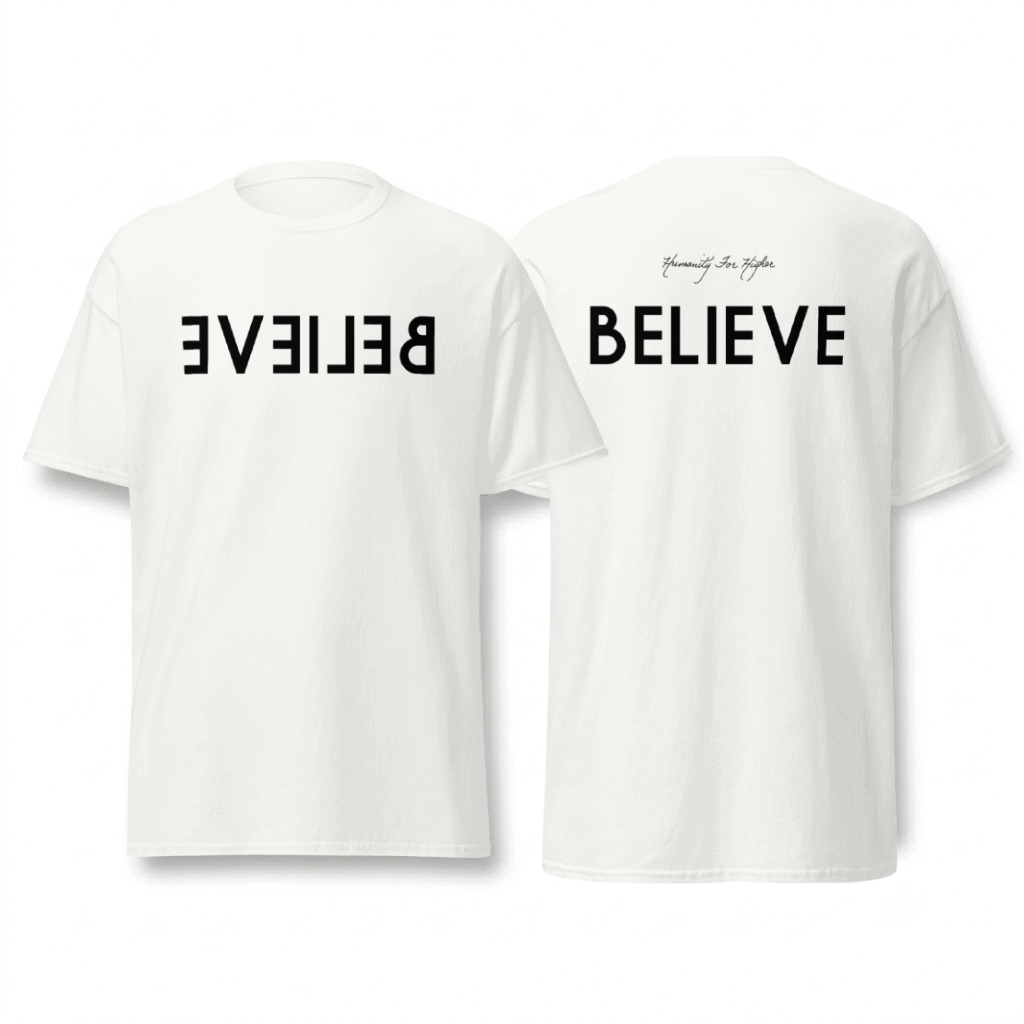 A black t-shirt with handmade charcoal artwork of jesus through a keyhole, with the backside of the shirt showing Humanity for Higher in white cursive text.